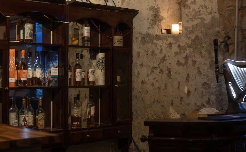 The Clubhouse bar, a dark timber cabinet of whisky and spirits