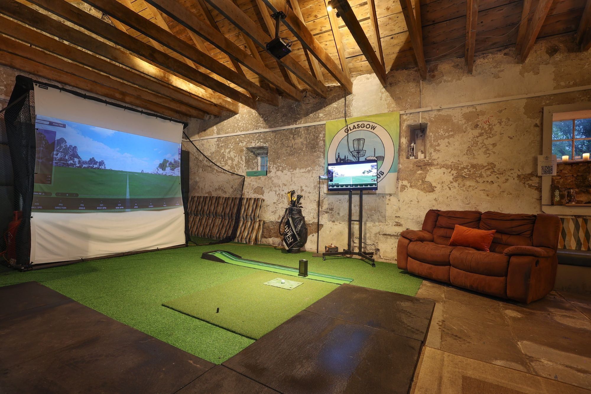 Leather sofas and the simulator bay in the Clubhouse