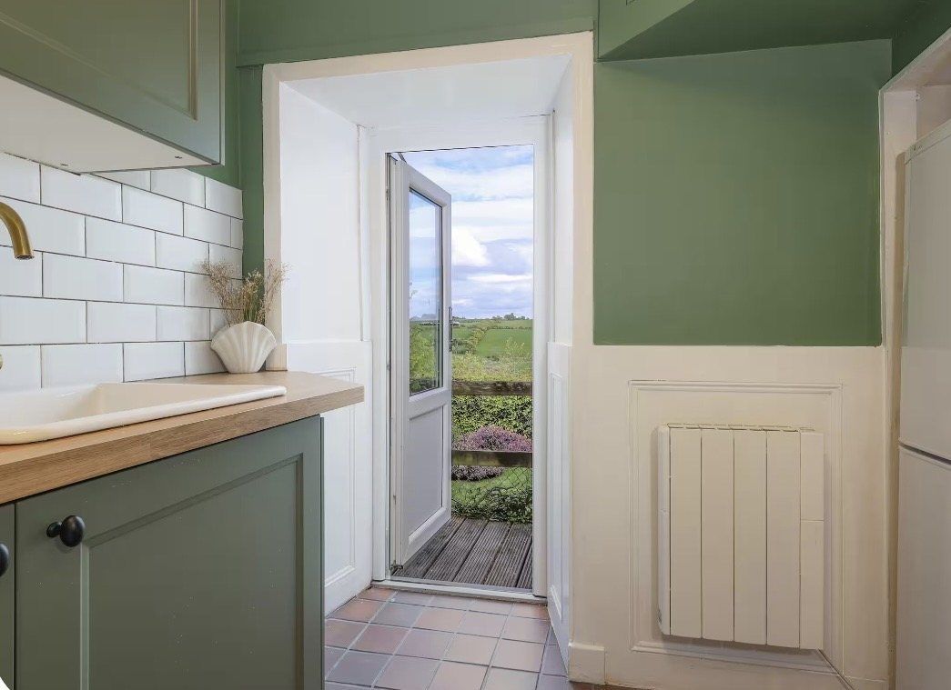 Kitchen door open to the fields beyond